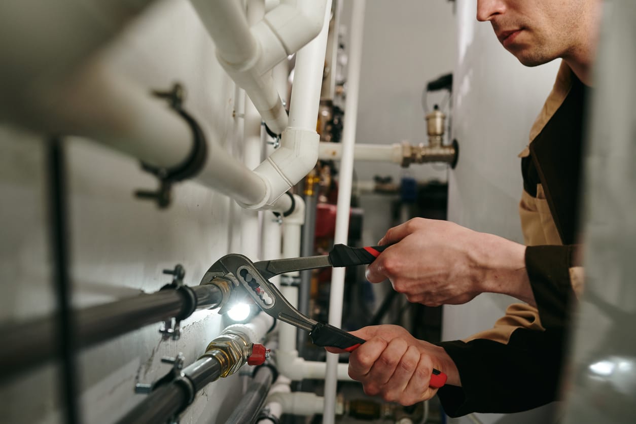 Plumbers maintaining commercial plumbing pipes in Palm Bay