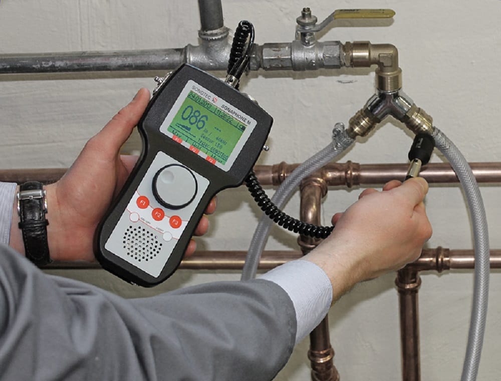Plumber testing pipes with electronic leak detection equipment in Palm Bay