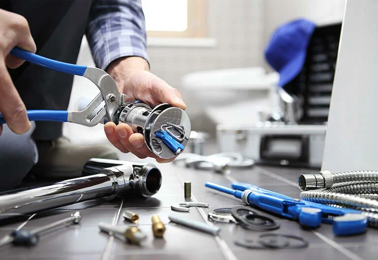 Technician repairing a plumbing fixture with professional tools in Palm Bay