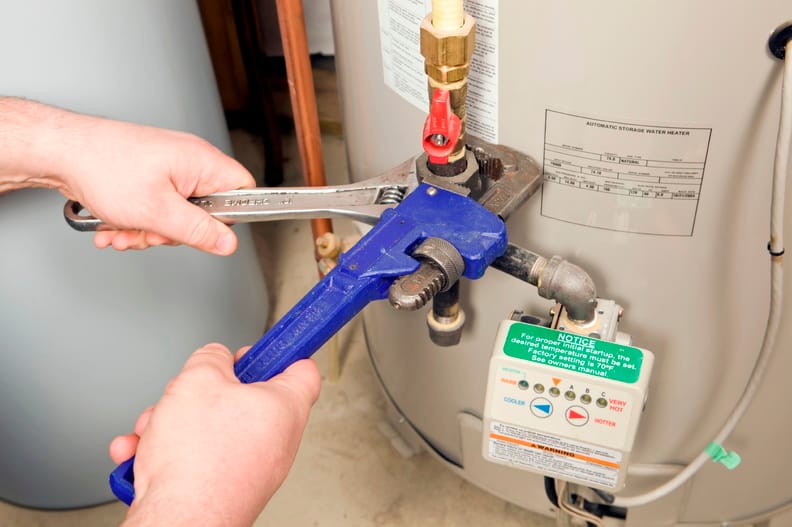 Plumber repairing a water heater valve in Palm Bay